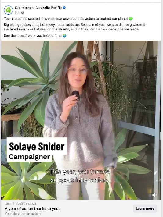 Solaye Snider, Greenpeace campaigner, speaking into microphone surrounded by potted plants