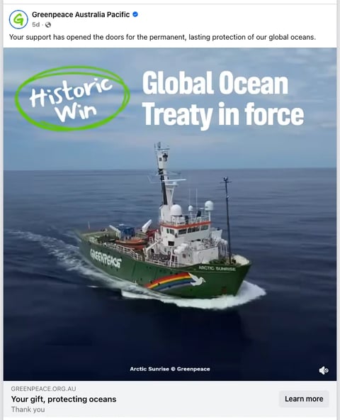 Greenpeace vessel Arctic Sunrise at sea with text Historic Win - Global Ocean Treaty in force