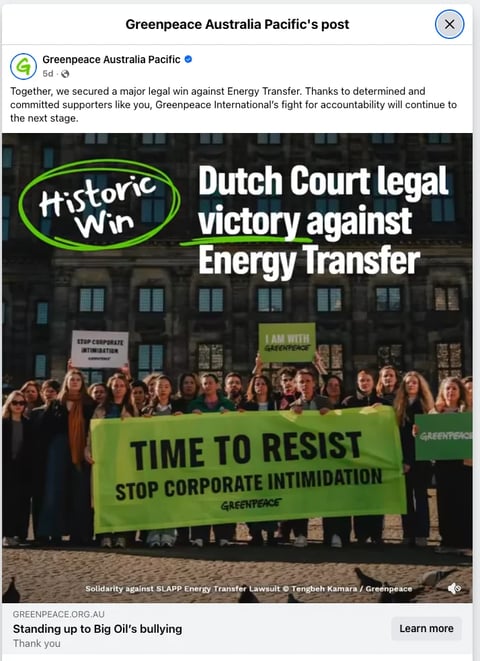 Greenpeace activists holding green banner reading Time to Resist Stop Corporate Intimidation outside court building celebrating Dutch legal victory against Energy Transfer